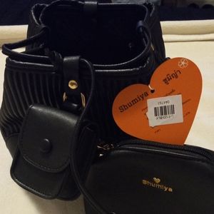 Dumplin worthy set with a small purse and ear buds holder included.